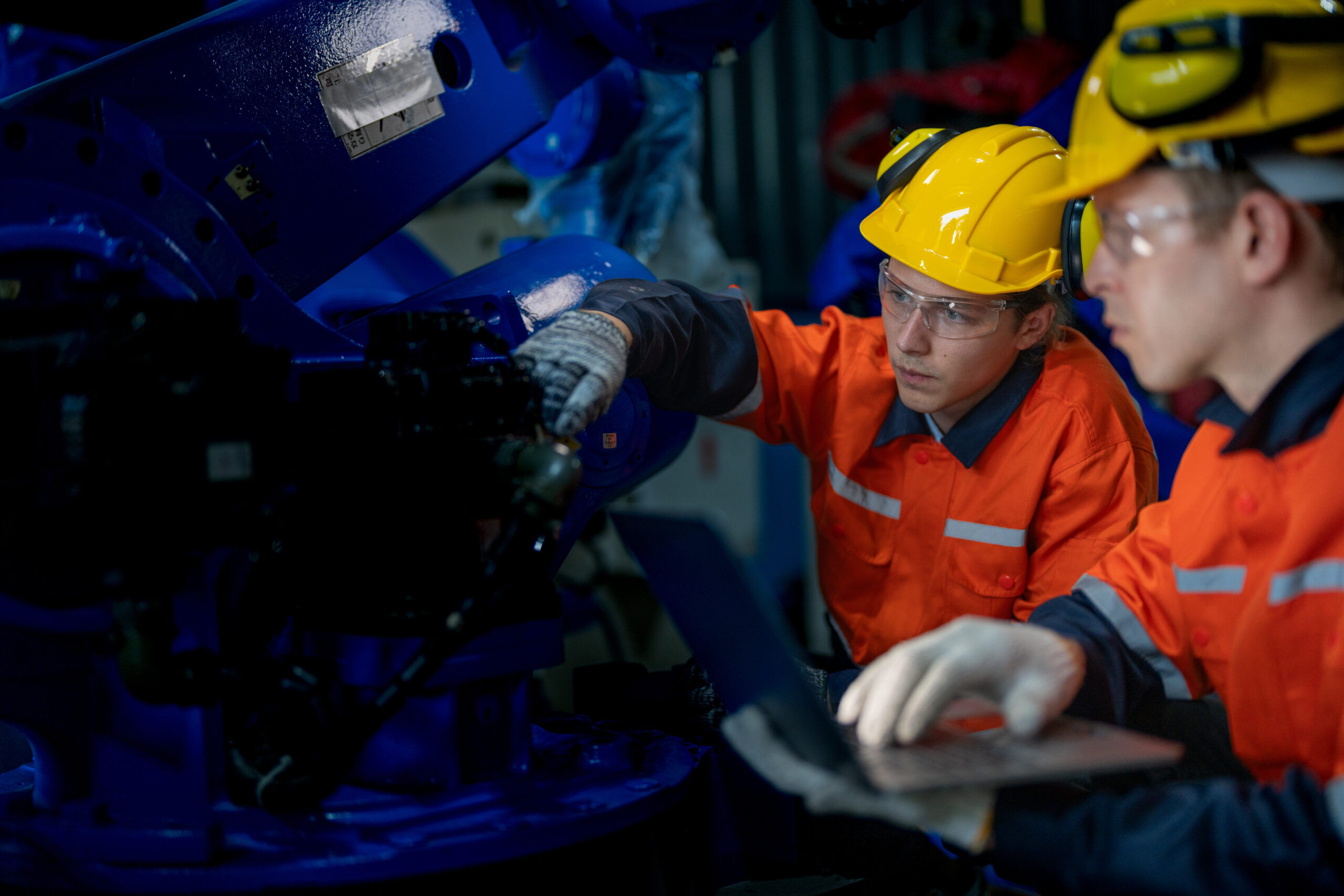 2 workers repairing waste equipment